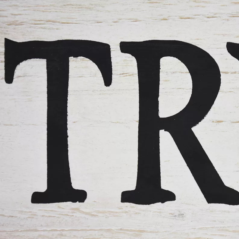 Whitewashed wood pantry sign close-up with bold black letters 'TR'