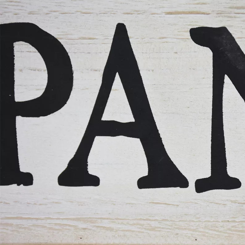 Whitewashed wood pantry sign close-up with bold black letters 'PA'