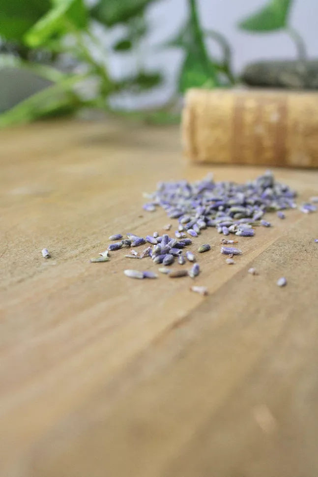 French lavender buds scattered on a wooden surface