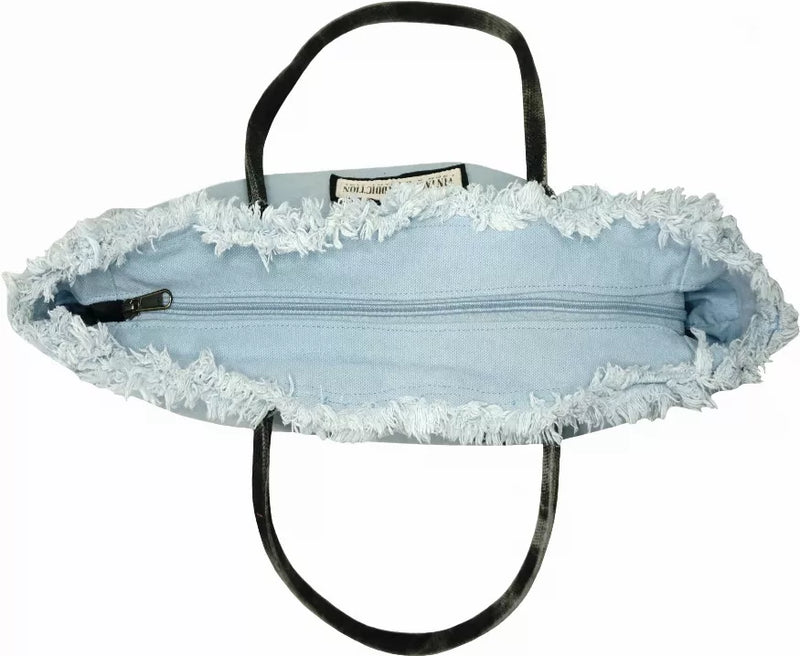 Light blue tote bag with black handles, lace trim, and open zip top