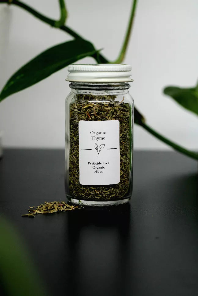 Glass jar of dried thyme with label reading Organic Thyme