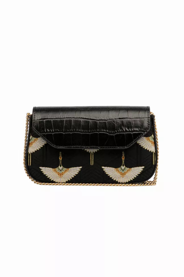 Black crossbody chain bag with flap, gold wing embroidery, and tassel charm
