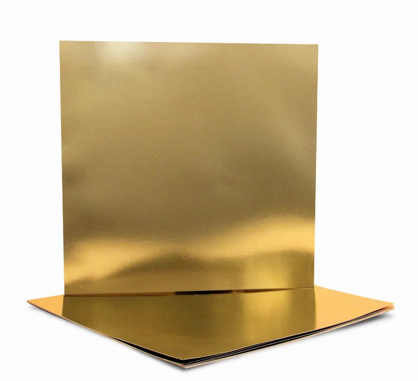 Gold metallic foil board sheets, stacked with one upright panel