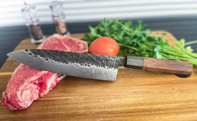 Chef knife with hammered blade and dark wood handle