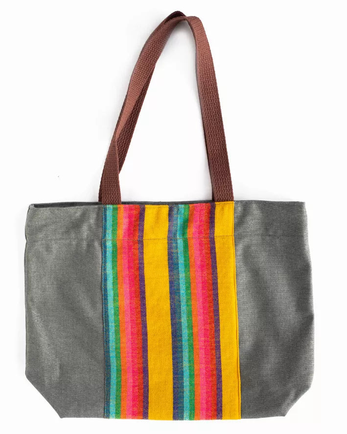 Anika tote bag with brown handles, gray canvas, and vertical rainbow stripe panel