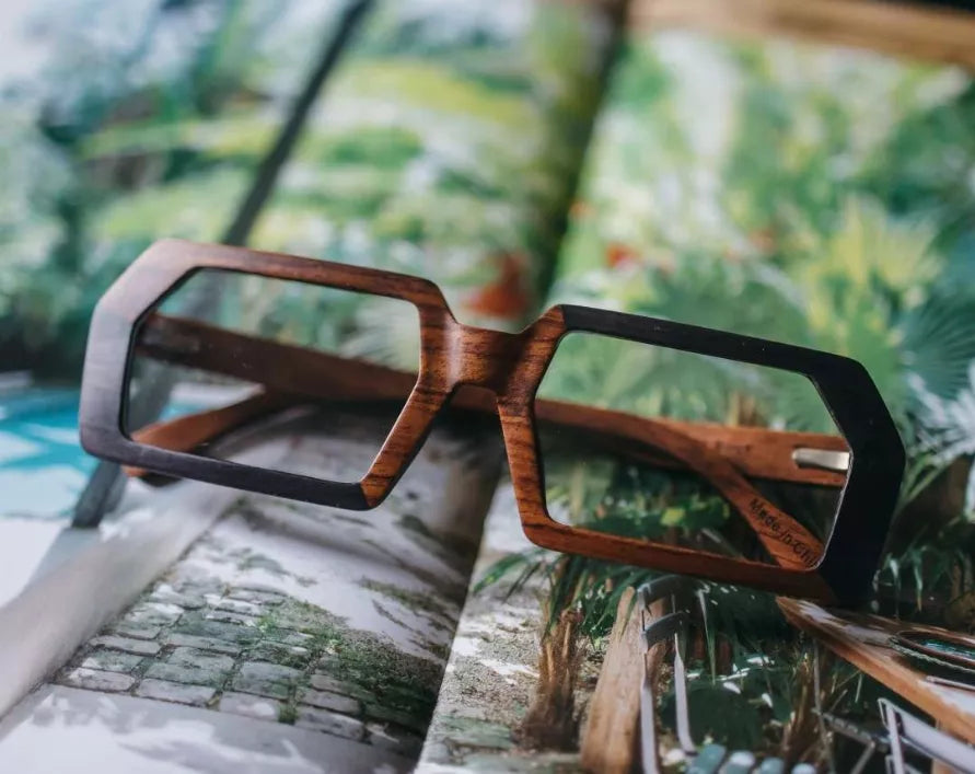 Wood and black square eyeglasses with clear lenses, worn outdoors