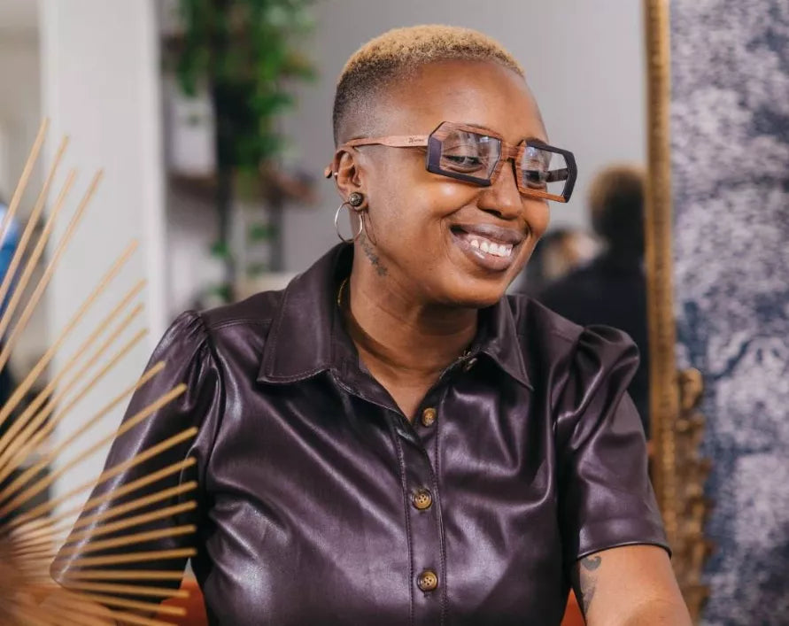 Person wearing square wooden eyeglasses with tinted clear lenses