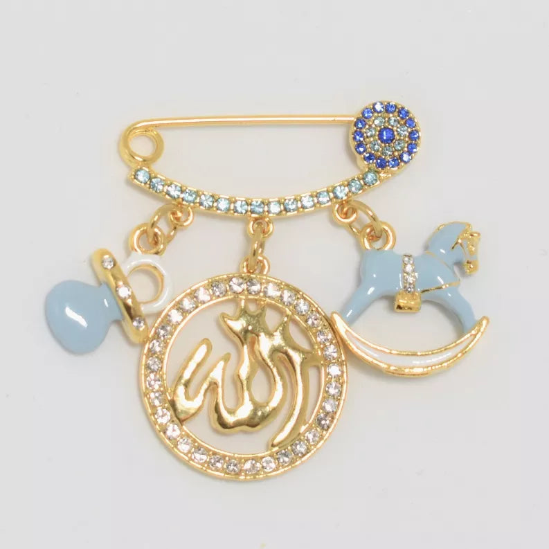 Gold-tone baby pin with blue heart, rocking horse charm, and round crystal calligraphy medallion