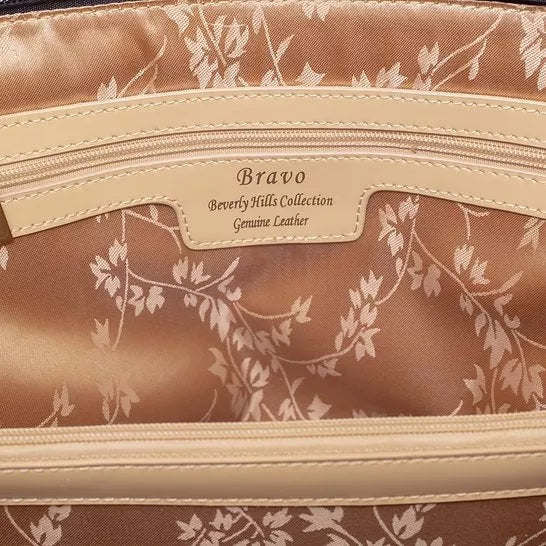 Leather handbag interior with 'Bravo' logo tag and leaf-pattern lining, zip pocket
