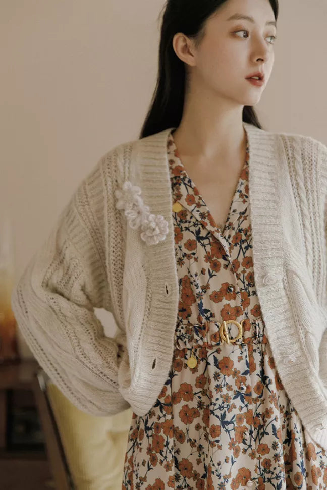 Crochet cardigan with textured knit, scalloped flower detail, and button front