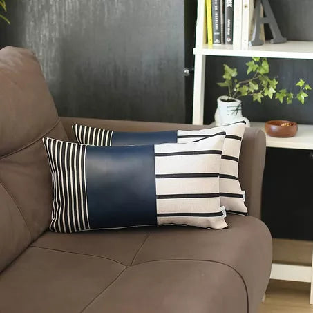 Navy and white striped faux leather throw pillow cover with vertical stripes on the left