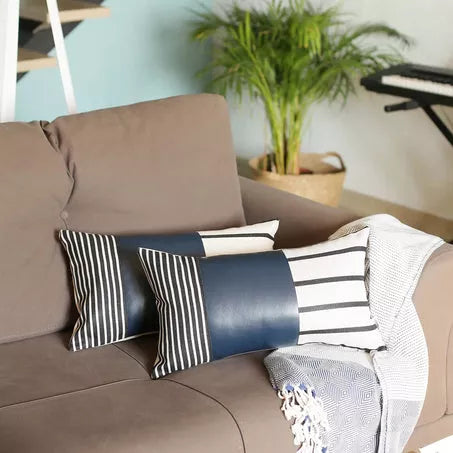 Navy and white striped faux leather throw pillow cover with horizontal stripes on the right
