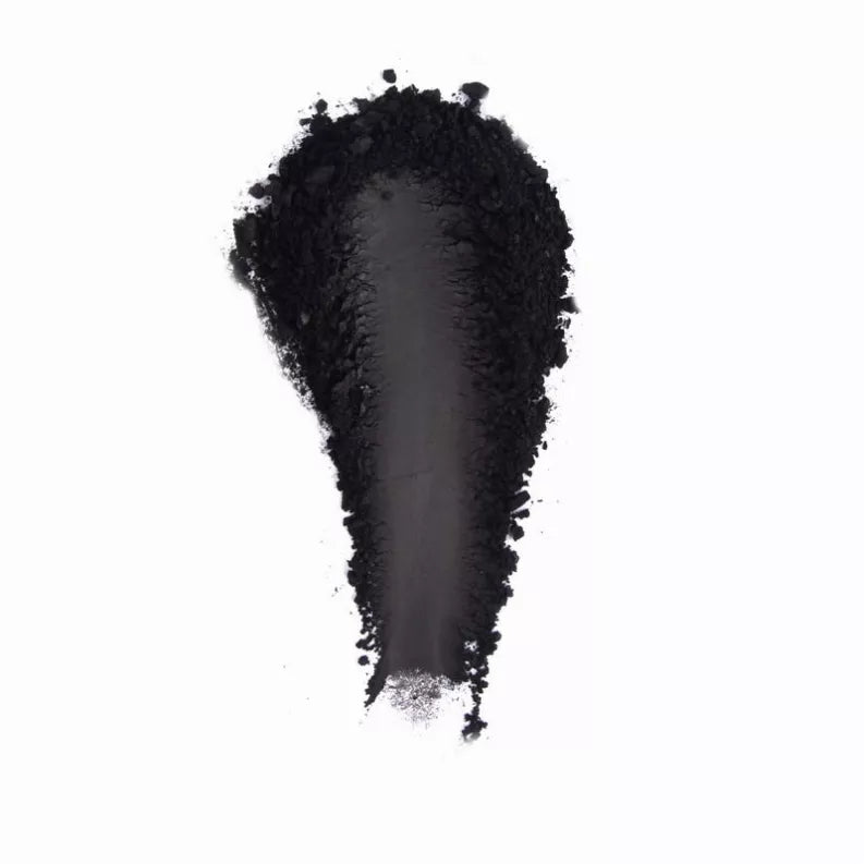 Black eyeshadow swatch with dense powder texture