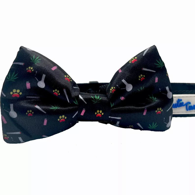 Black dog collar with fabric bow featuring paw, bone, and leaf pattern