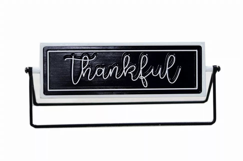 Rotating tabletop metal sign with black panel and white cursive 'Thankful' on black stand