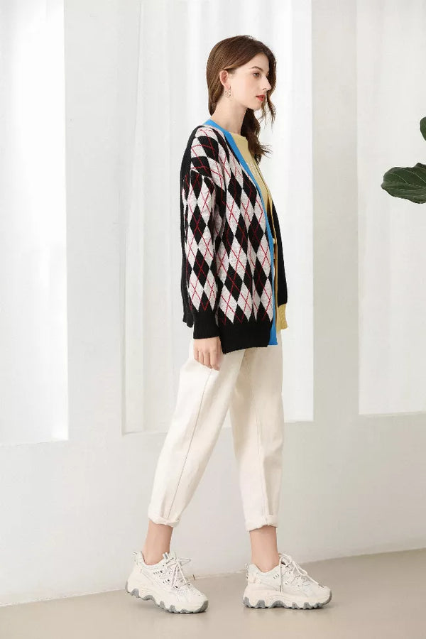 Side view of black argyle splicing cardigan with diamond knit pattern and blue trim