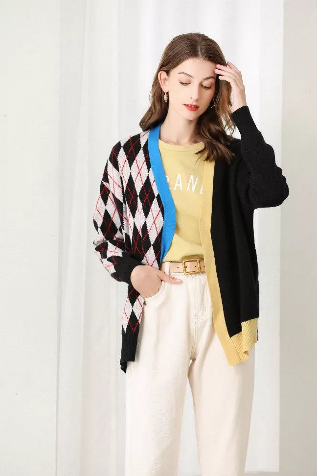 Close view of black argyle splicing cardigan with diamond knit, blue trim, and open front