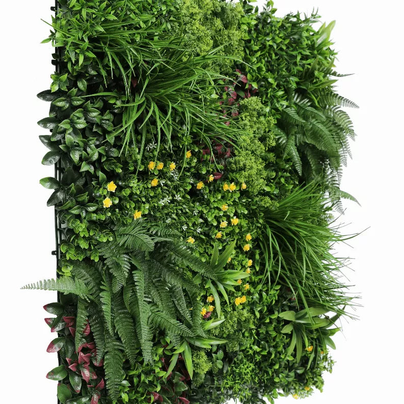 Artificial vertical garden wall panel with lush faux foliage, ferns, and scattered yellow flowers