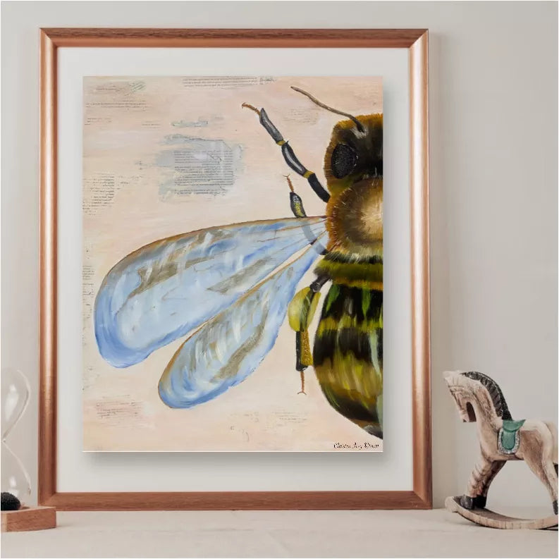 Framed bee art print with blue wings and yellow-green body on light background