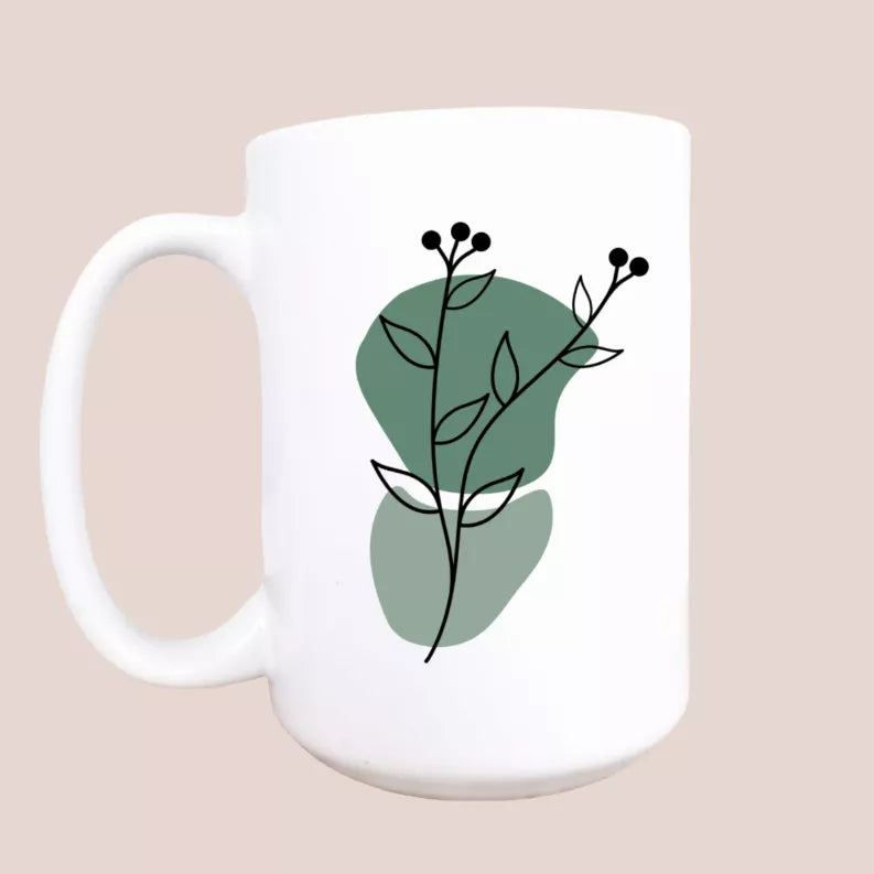 White ceramic coffee mug with green abstract botanical flower illustration and handle