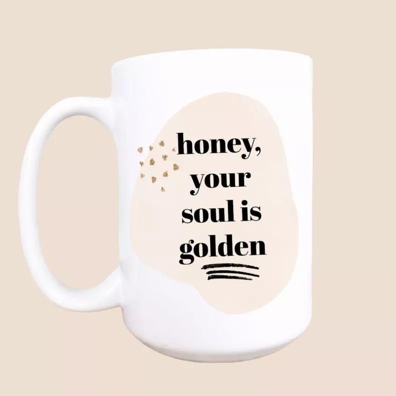 White ceramic coffee mug with 'honey, your soul is golden' text print