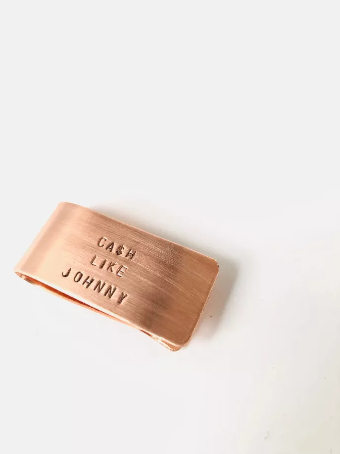 Copper money clip with “Cash Like Johnny” engraving, top view