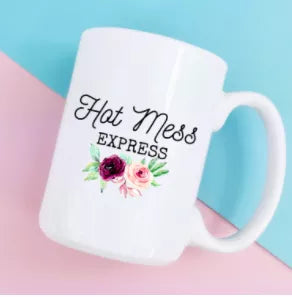 White ceramic coffee mug with 'Hot Mess Express' text and flower design, curved handle