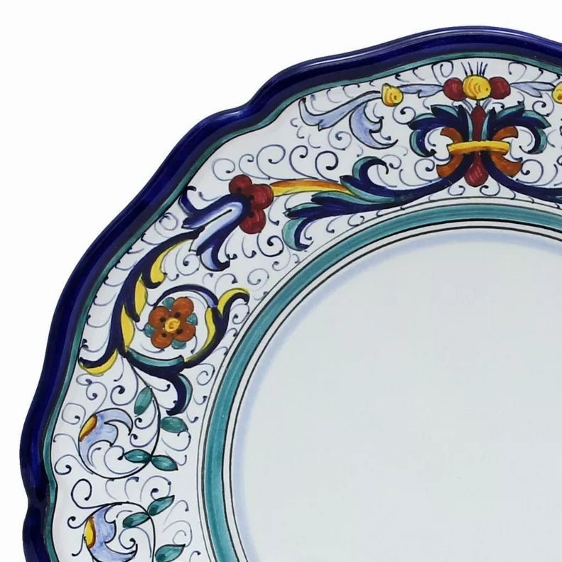 Decorative blue dinner plate rim with turquoise inner ring and colorful floral scroll design