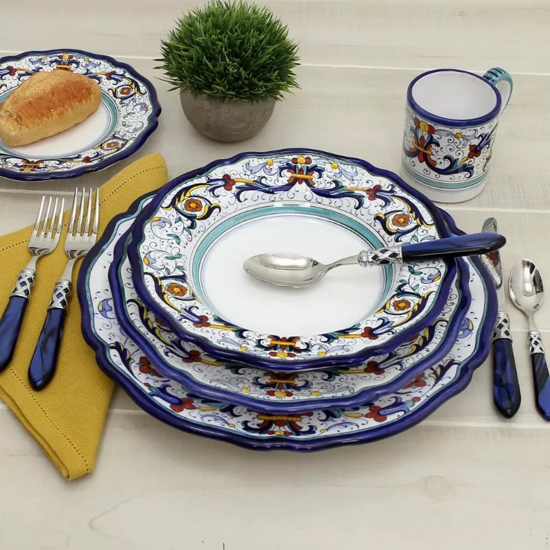 Stacked decorative blue dinner plates with turquoise center ring and colorful floral border