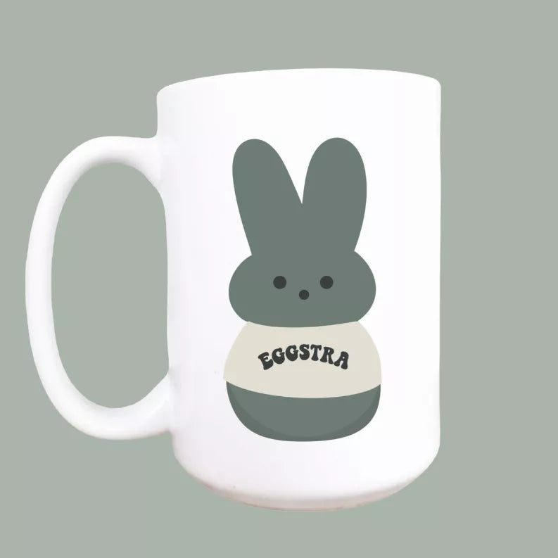 White ceramic coffee mug with bunny graphic and EGGSTRA text, 15oz