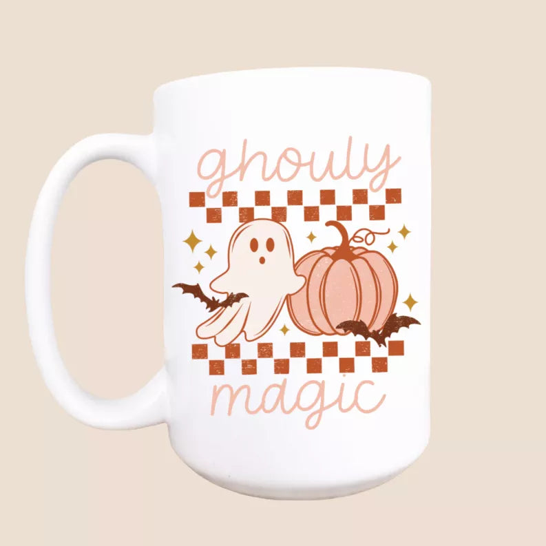 White ceramic coffee mug with ghost and pumpkin graphic, 'ghouly magic' text