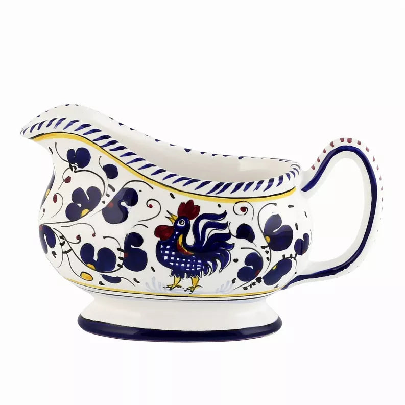 Deruta-style ceramic sauce boat with blue rooster pattern and curved handle