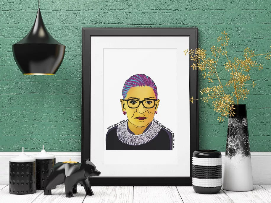 Framed pop art portrait print of Ruth Bader Ginsburg, shown full in black frame.