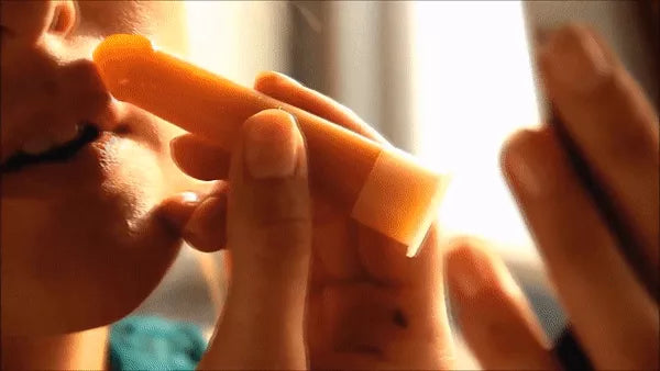 Hard wax body stick application on face with fingers