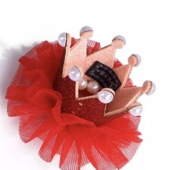 Red pet crown with mesh tulle skirt, white pom-poms, and gold beaded base