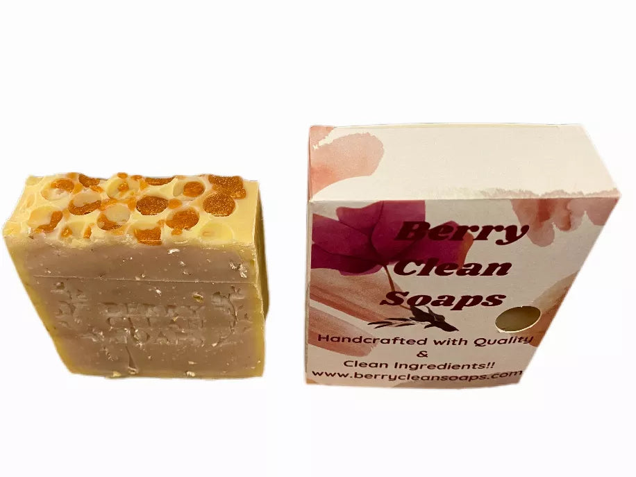 Honeycomb soap bar with honeycomb pattern beside Berry Clean soaps box packaging