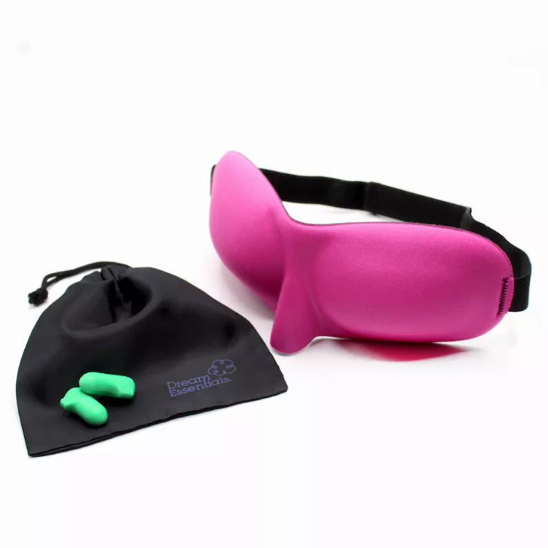 Pink sleep mask with black drawstring pouch and green earplugs