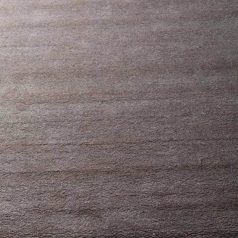 Close-up of textured medium gray rug pile with subtle speckled effect