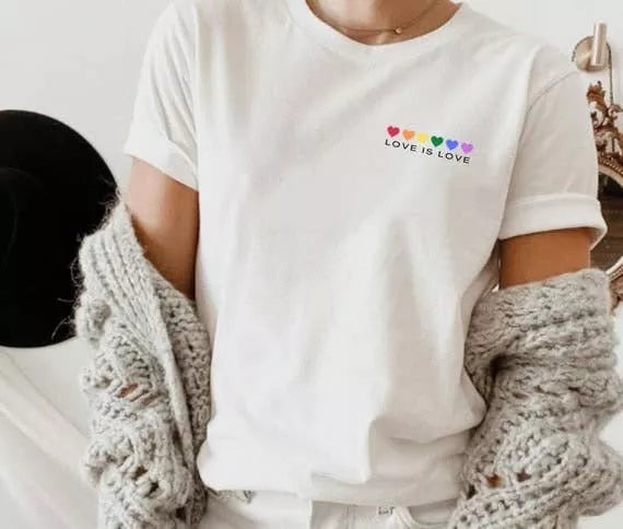 White T-shirt front close-up with Love Is Love rainbow hearts text