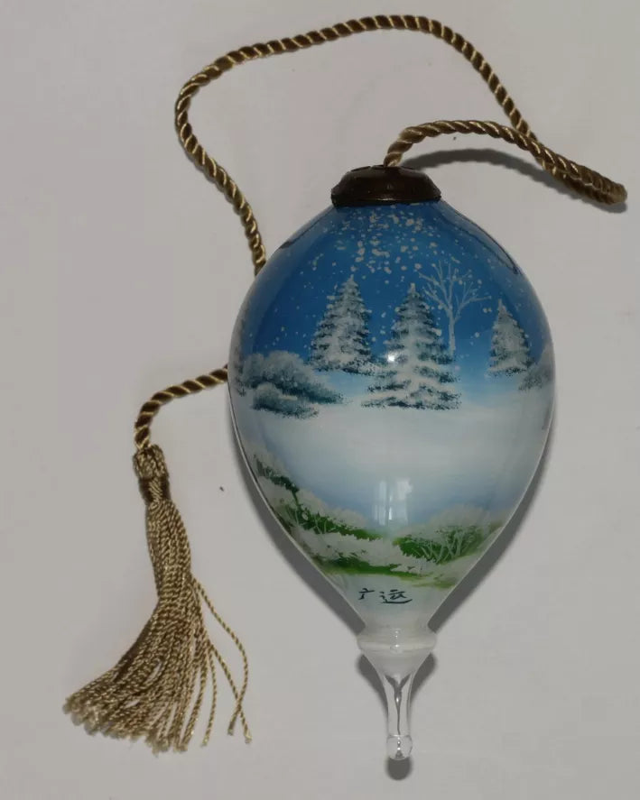 Hand-painted glass ornament with snowy blue winter scene and hanging tassel