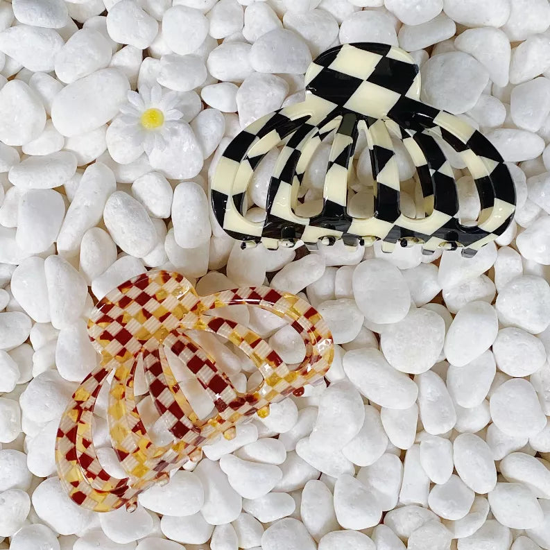 Checkerboard hair claw clip pair: black and cream top, red and cream bottom