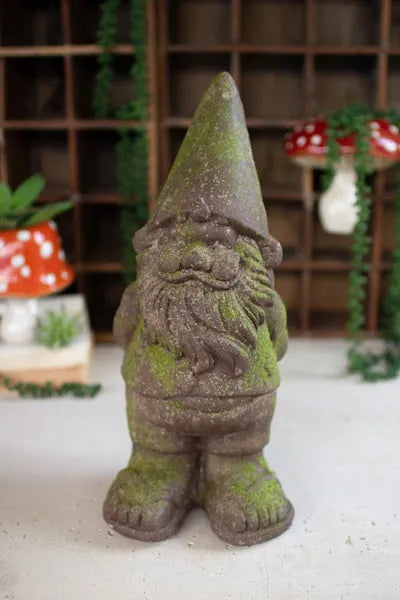 Gray faux concrete gnome garden statue, standing with pointed hat and beard.