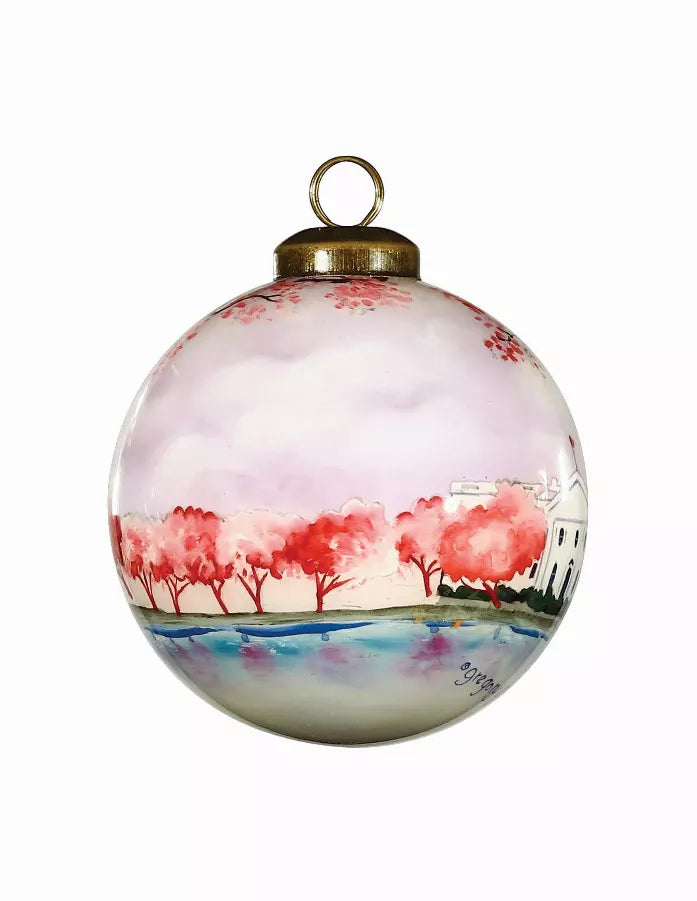 Hand-painted glass ball ornament with red tree line and Capitol dome skyline