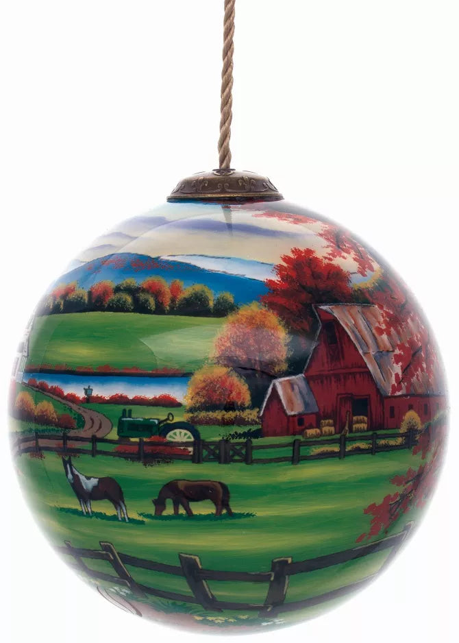 Hand-painted glass farm ornament with autumn landscape and hanging cord