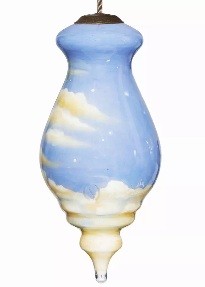 Hand-painted glass ornament with blue sky and cream cloud pattern, hanging loop