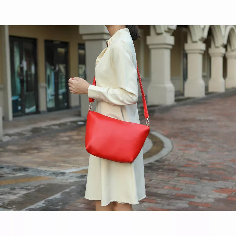 Reversible tote bag with red body and shoulder strap, paired with a zip pouch