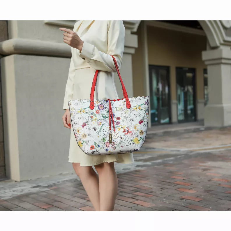 Reversible tote bag in white floral print with red handles and crossbody strap