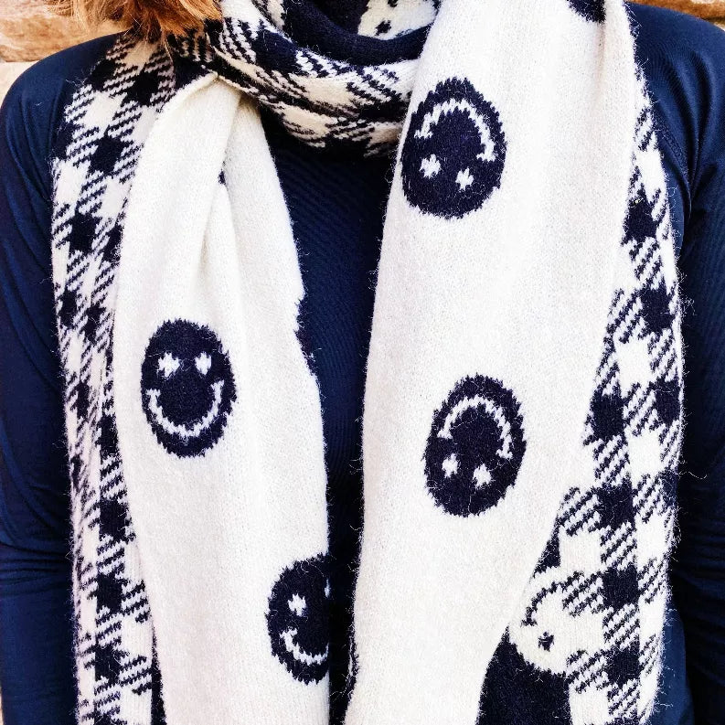 Navy-and-white scarf close-up with smiley circles and black plaid sections