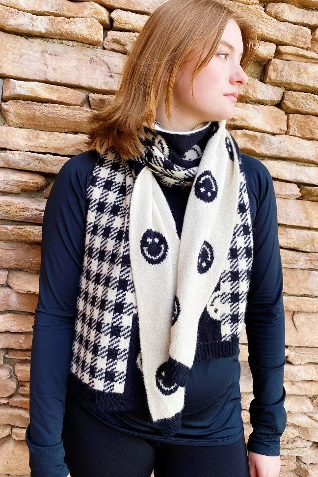 Cozy navy-and-white checked scarf worn around neck with smiley-circle pattern