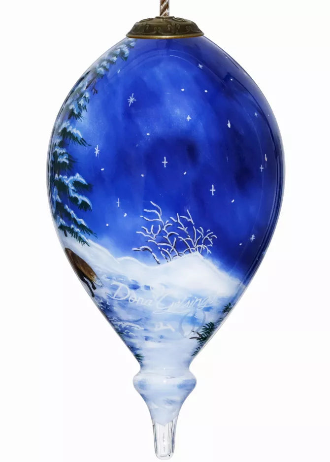 Hand-painted glass ornament with blue snowy landscape and starry sky